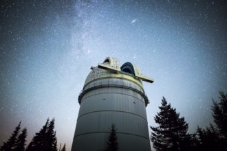 Rozhen astronomical observatory under the night sky stars. Blue sky with hundreds of stars of the