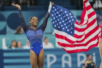 Simone Biles (USA) of the United States celebrates with the fans after winning the Artistic