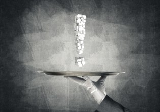 Cropped image of waitress's hand in white glove presenting multiple cubes in form of exclamation