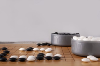 Wooden goban and dice for playing go, copy space, selective focus