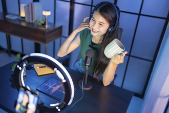 Content creator Young asian woman influencer creating content in home studio entertainment and