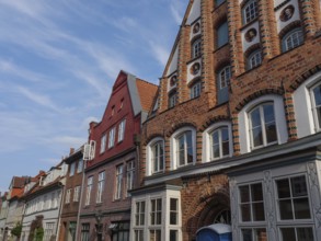 Street scene with historic brick buildings under a blue sky, lüneburg, germany