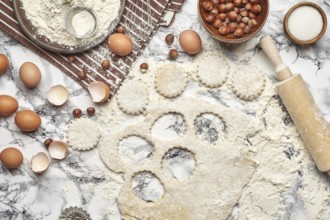 Close-up shot. Top view of a kitchenware and baking ingredients on a marble table background. There