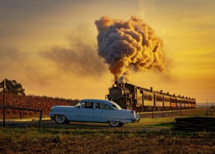 A View of an Antique Steam Passenger Train Approaching at Sunrise With a Full Head of Steam and