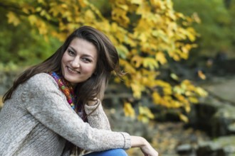 Smiling, happy girl portrait in autumn park