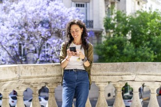 Urban woman engaged in texting on her smartphone