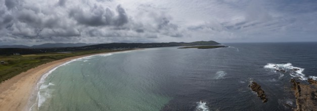 A panorama aerial view of the golden sand beach and turquoise waters of the beach at Narin-Portnoo