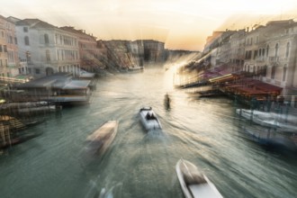 Evening light at sunset, view over the Grand Canal, gondola and boats, from the Rialto Bridge, zoom