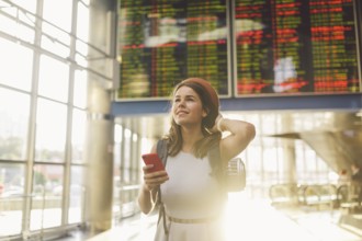Theme travel and tranosport. Beautiful young caucasian woman in dress and backpack standing inside