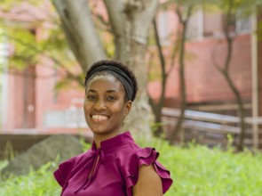 Woman in a purple blouse smiling in a green outdoor park setting, Taken in Daejeon, South Korea