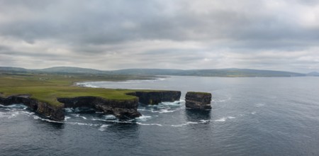 A drone panorama landscape of the Downpatrick Head sea stack and cliffs and coastline of northern