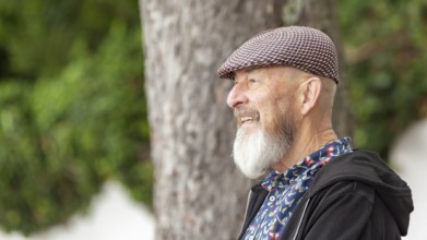 An image of an old man with a beard outdoor