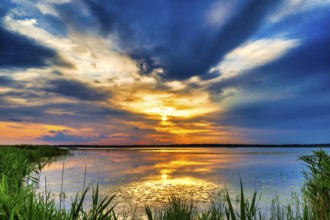 A Beautiful Golden Sunset on The Lake. Amazing Sunset Reflection in The Water