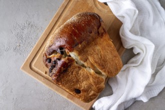 Wheat flour bread with raisins on a wooden board