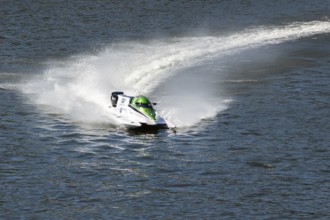 PESO DA REGUA, PORTUGAL - SEPTEMBER 15, 2024: White Powerboat Makes Turn with Splashes of Water