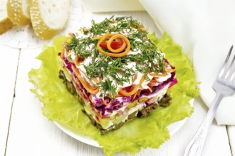 Puff salad with beef, boiled potatoes and beets, pears, spicy Korean carrots, seasoned with