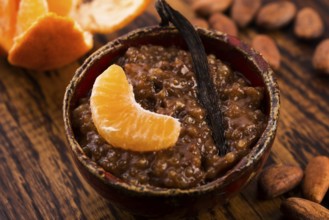 A bowl of chocolate tapioca pudding with fruits
