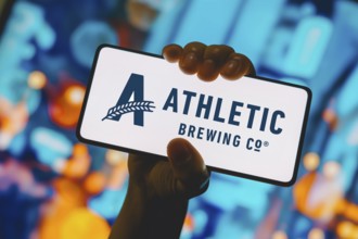 In this photo illustration, the Athletic Brewing Company logo is displayed on a smartphone screen