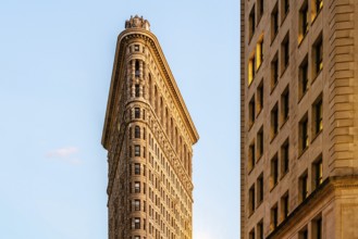 Low angle view of Flatiron Building in Manhattan against blue sky