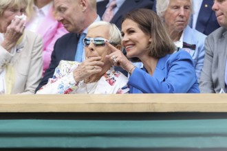 Martina Navratilova and her partner Julia Lemigova watching the action at the 2024 Wimbledon