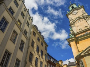 Historic buildings and church tower under blue sky with clouds, stockholm, baltic sea, sweden,