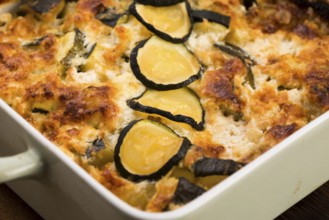 Casserole with cheese and courgette in baking dish
