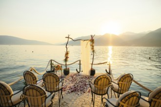 Wooden arch for the wedding ceremony at sunset. On the shore of the Bay of Kotor, Tivat, Montenegro