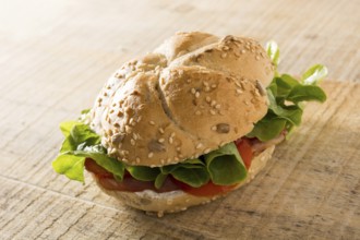 Sandwich with fresh smoked meat, cheese, lettuce and tomato with homemade ketchup