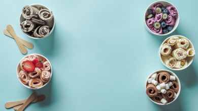 Rolled ice creams in cone cups on blue background. Different iced rolls top view or flat lay. Thai
