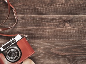 Top view image of vintage old camera on wooden table background. Flat lay. Copy space for text