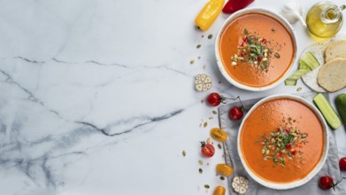 Gaspacho soup on white marble tabletop. Two bowls of traditional spanish cold soup puree gaspacho
