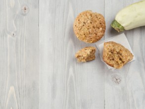 Top view of muffin with zucchini, carrots, apple and cinnamon on gray wooden background. Sweet