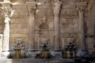 Old stone fountain in the campaign on the Cretan