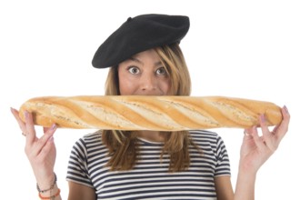 Young French girl with typical French barret and striped shirt eating bread isolated over white