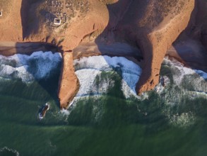 Aerial top view on Legzira beach with arched rocks on the Atlantic coast at sunset in Morocco