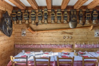 Cow bells displayed in restaurant of mountain farm. Vosges, Alsace, France