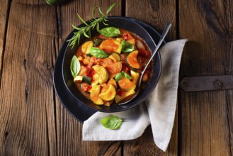 Vegetarian courgette ratatouille with tomato sauce and herbs