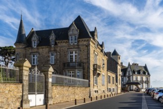 Roscoff, France, July 31, 2018: Old residential buildings and health resorts at evening against sky