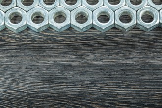 Stainless nuts on wooden board