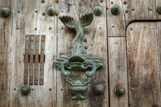 Artful door knocker at an old wooden door, Cartagena, Colombia