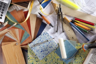 Architect or interior designer workplace desk and design tools with lots of construction material