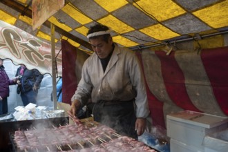 24.12.2017, Kyoto, Japan, Asia, A man prepares freshly roasted yakitori beef skewers at a stall in