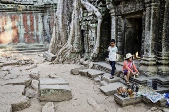 Souvenir trinket stall vendor in angkor wat famous landmark buddhist temple ruins near siem reap