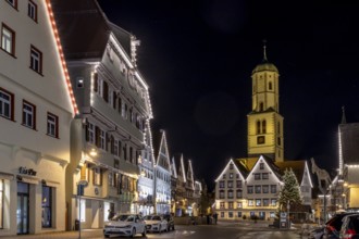 Night photo of historic buildings around the market square with Christmas tree and Christmas lights