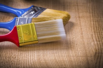 Very close up view on stack of three paint brushes