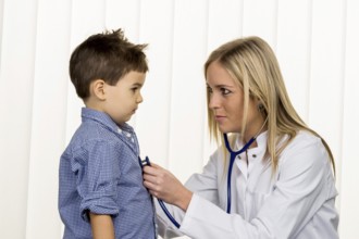 Doctor and little boy, symbol for diseases, diagnostics, heart defects