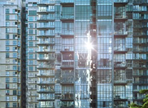 Urban abstract close up view of multiple steel and glass windows facade office building