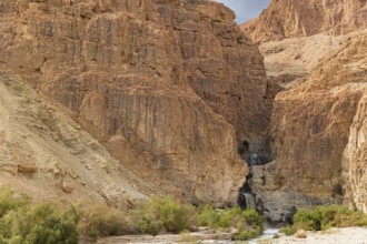 Cascading waterfall in a narrow gorge. The Judean Desert around the Dead Sea after heavy winter