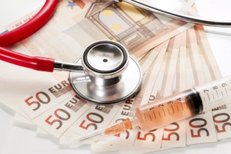 Stethoscope and syringe are on 50 euro notes