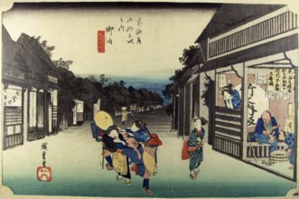 Goyu: Main street of the village at nightfall and female touts dragging travellers into the
